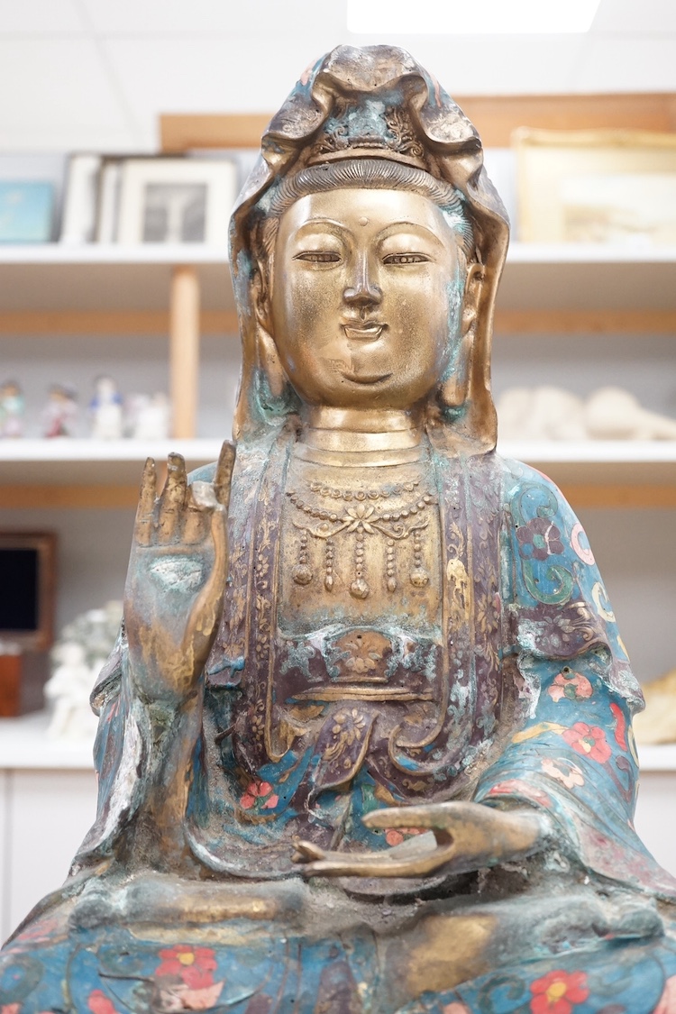 A large Chinese cloisonné enamelled bronze figure of Guanyin, 43cm high. Condition - some damage to edging of garment